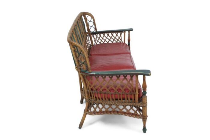 3 seat american art deco style wicker sofa with painted floral embellishments on the seat backs and 1734