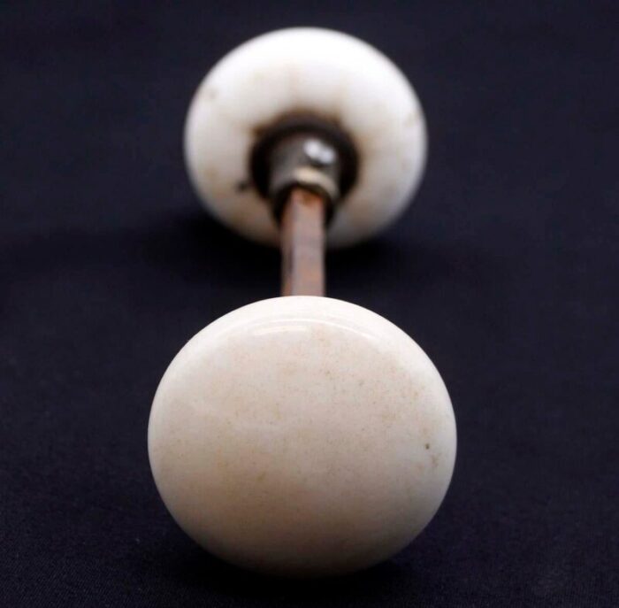 pair of mid 20th century white ceramic door knobs with black cast iron shanks 0509