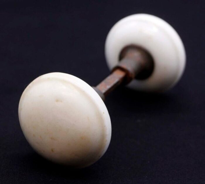 pair of mid 20th century white ceramic door knobs with cast iron shanks 9377