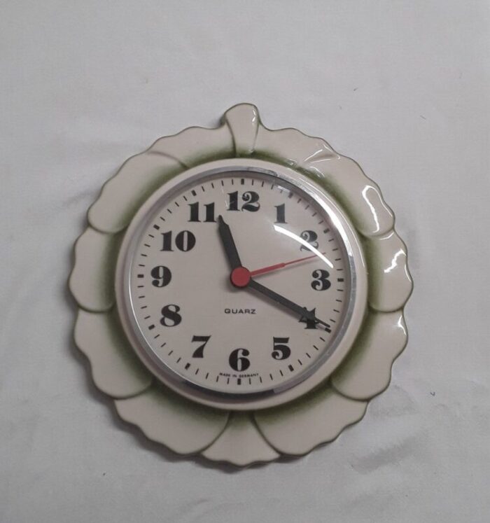 vintage german wall clock with a white and green ceramic housing in the shape of a leaf 1970s 1