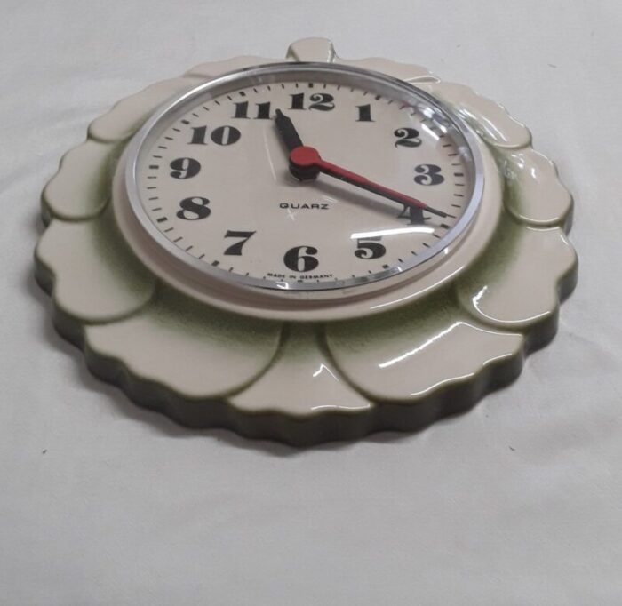 vintage german wall clock with a white and green ceramic housing in the shape of a leaf 1970s 2