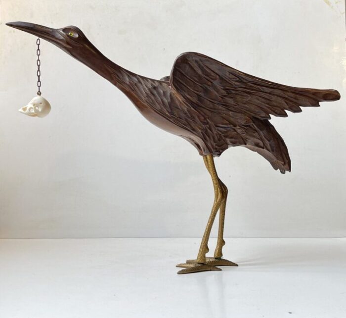 wooden crane bird with suspended skull 1940s 1